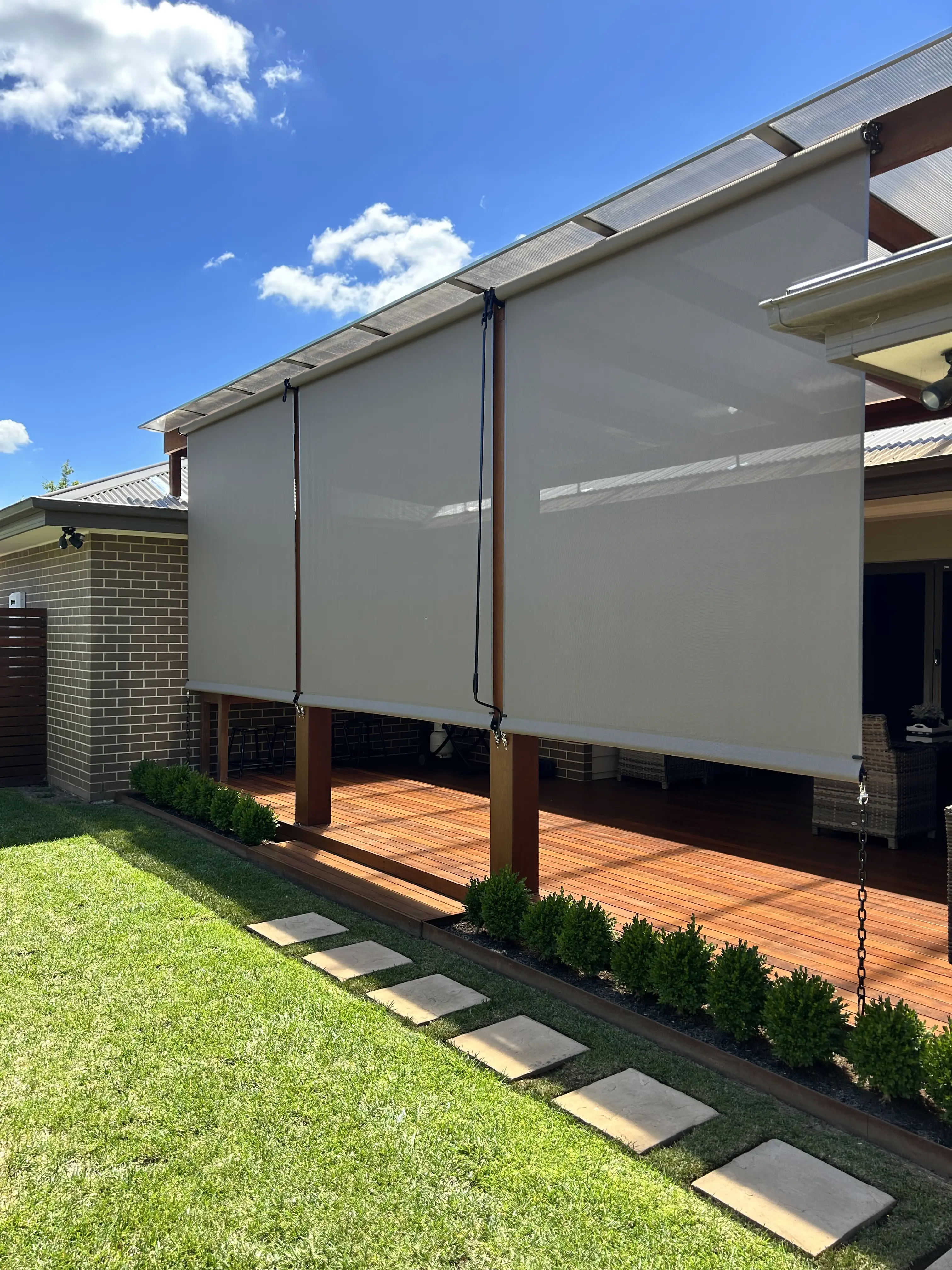Straight drop outdoor blinds installed on patio